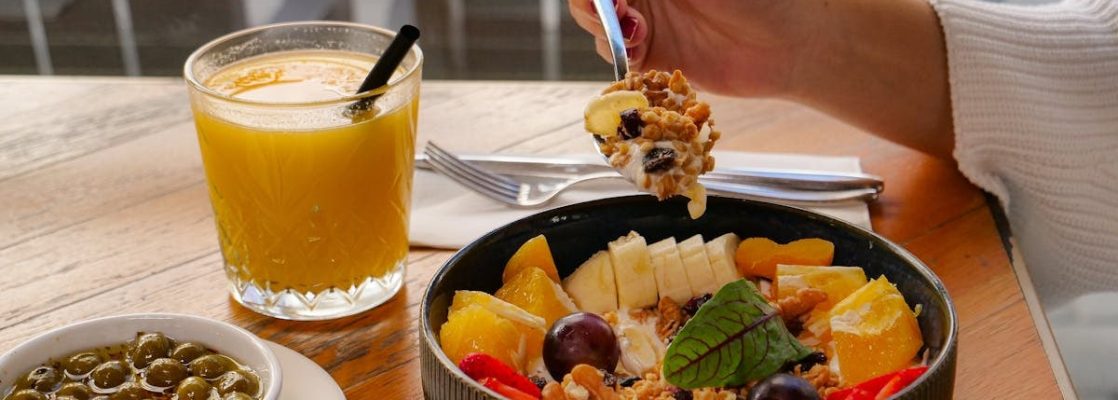 Enjoy a nutritious breakfast with fruit, nuts, and juice in a calm setting in İzmir, Türkiye.